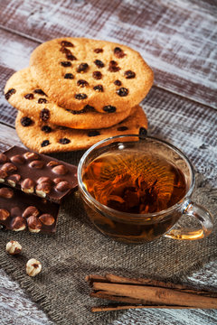 cookie chocolate and tea on a wooden table