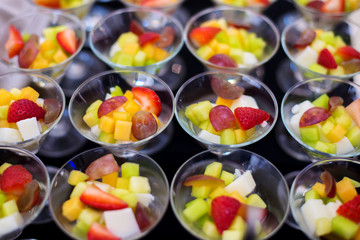 sliced several fruit prepare in row of glasses