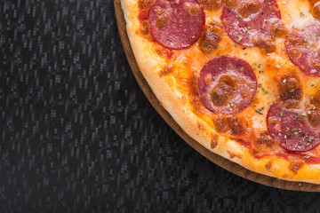 Closeup of hot pizza with salami sausage