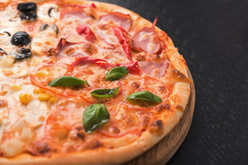 mix pizza with olive, bacon, basil and chicken