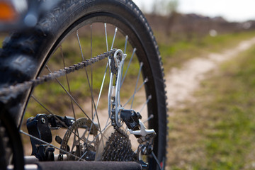 bicyclist repairs bicycle amongst hills