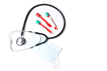 Test tubes with blood test and stethoscope on white background