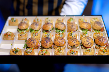 mini burger canape selection on slate platter
