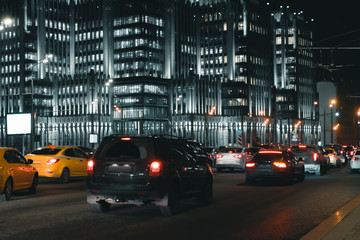 Fototapeta na wymiar Cars in motion on the road in night city
