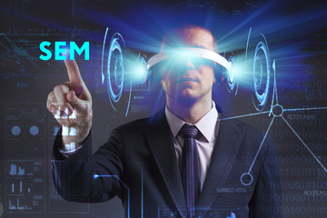 Business, Technology, Internet and network concept. Young businessman working in virtual reality glasses sees the inscription: SEM