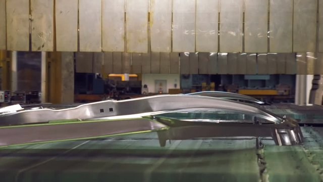 movement of details of car body by tape in old automobile factory, making car body