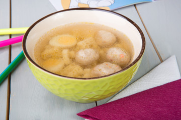 Meatball soup on wooden board table