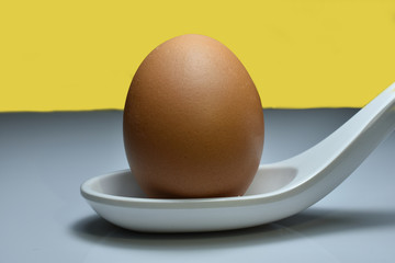 The eggs are in a white spoon.