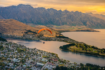 Paragliding over Queenstown and Lake Wakaitipu from viewpoint at Queenstown Skyline, New Zealand