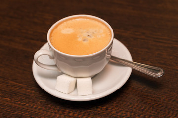 A cup of coffee with sugar