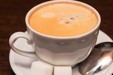 A cup of coffee with sugar