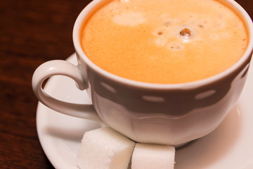 A cup of coffee with sugar