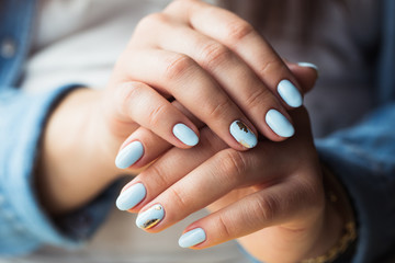 beautiful manicure. Gel polish coating in blue, embossing.