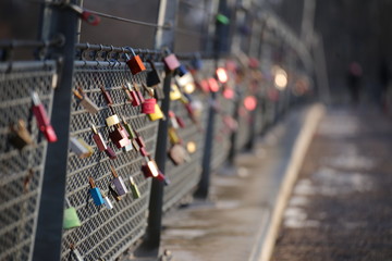 Love locks hanging on a bridge railing