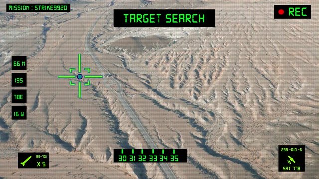 Viewfinder of a military helicopter / plane looking for a target to shoot and bomb. Desert area.