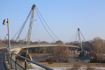 Fototapeta na wymiar Herrenkrugsteg, a suspension bridge for pedestrians and cyclists in Magdeburg, Germany