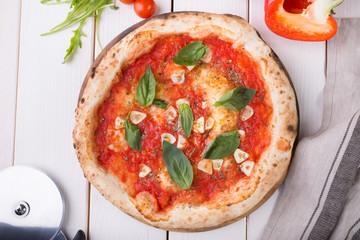 Whole pizza on wooden board