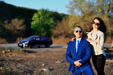 Business man and girl looking at the sunset