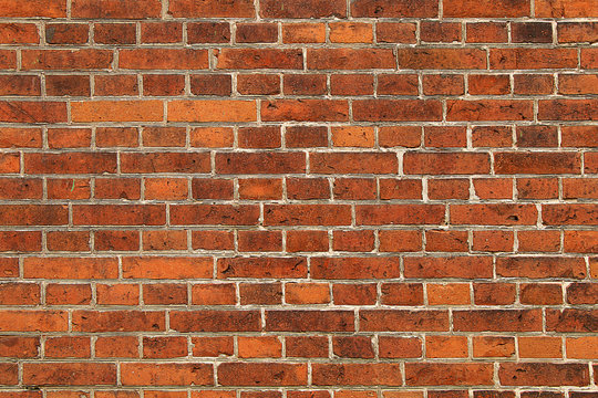 Wall of bright red brick with white seams