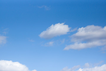 Naklejka na ściany i meble White clouds against a blue sky