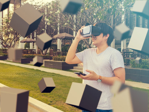 Visual reality concept.Young Asian man using Visual reality or VR headset man getting experience using VR-headset glasses.
