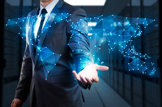businessman showing global network mesh with server room background