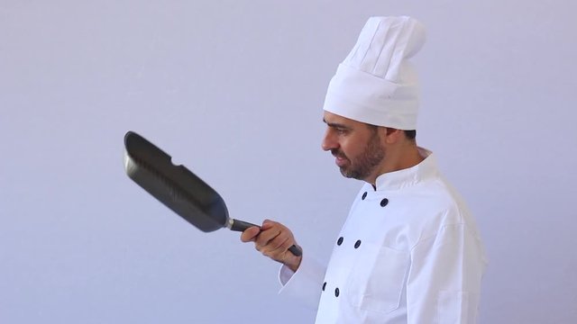 Extremely funny cook in the kitchen wearing chef uniform