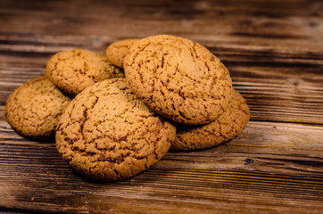 Stack of the oatmeal cookies on wooden table