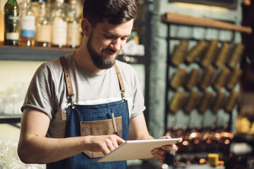 Bartender using tablet PC at a bar counter