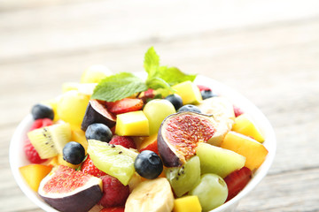 Fresh fruit salad on a grey wooden table