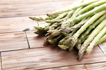 Green asparagus on brown wooden table