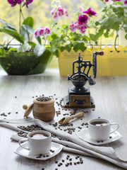 coffee grinder with coffee beans on a wooden table. 