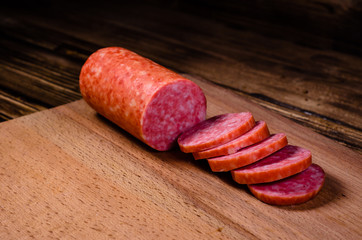 Sliced salami sausage on cutting board