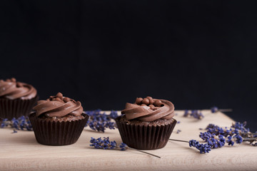 Chocolate Cupcakes on a wooden chopping board and lavender flowers
