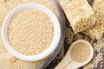 Amaranth seeds and energy bars on wood