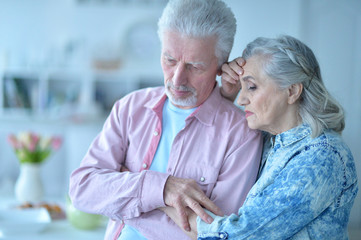 Beautiful sad elderly couple