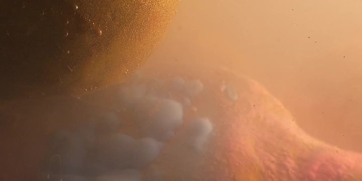 Abstract spherical models made of plasticine, immersed in liquid. Closeup. 4K. Camera RED.
