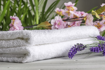 Obraz na płótnie Canvas Composition of towels and flowers. Spa therapy concept