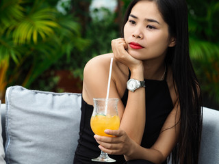 Beautiful young brunette vietnam girl wearing black dress