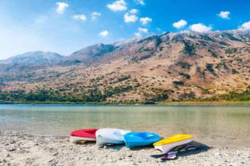 Colorful kayaks on the coast of lake. Crete, Greece