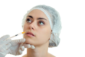 young beautiful girl in a special hat at a cosmetologist is isolated on a white background