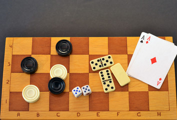Various board games chess board, playing cards, dominoes. Hobby. Metaphor for games and gambling.