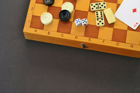 Various board games chess board, playing cards, dominoes. Hobby. Metaphor for games and gambling.