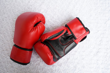 Red boxing glove on white fur textured background