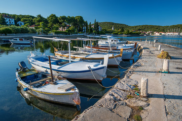 Fototapeta na wymiar Small fishing boats in local port in Croatia