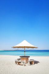 Sun umbrella on a beach, summer holidays concept, space for text.