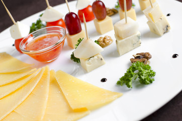 Assorted of different cheeses on a white plate