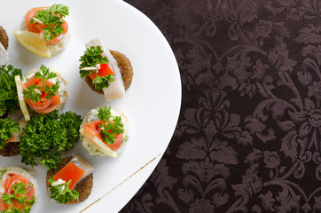 Fish canapes on a white plate