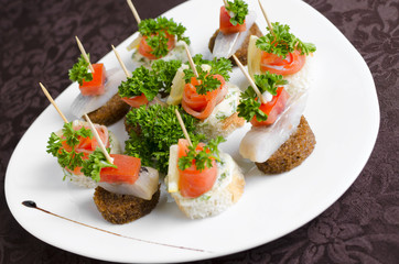 Fish canapes on a white plate