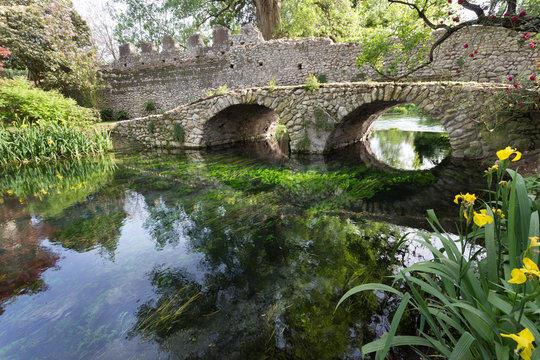 Ancient bridje on the crystalline wather in the Garden of Ninfa in the province of Latina, Italy, Europe